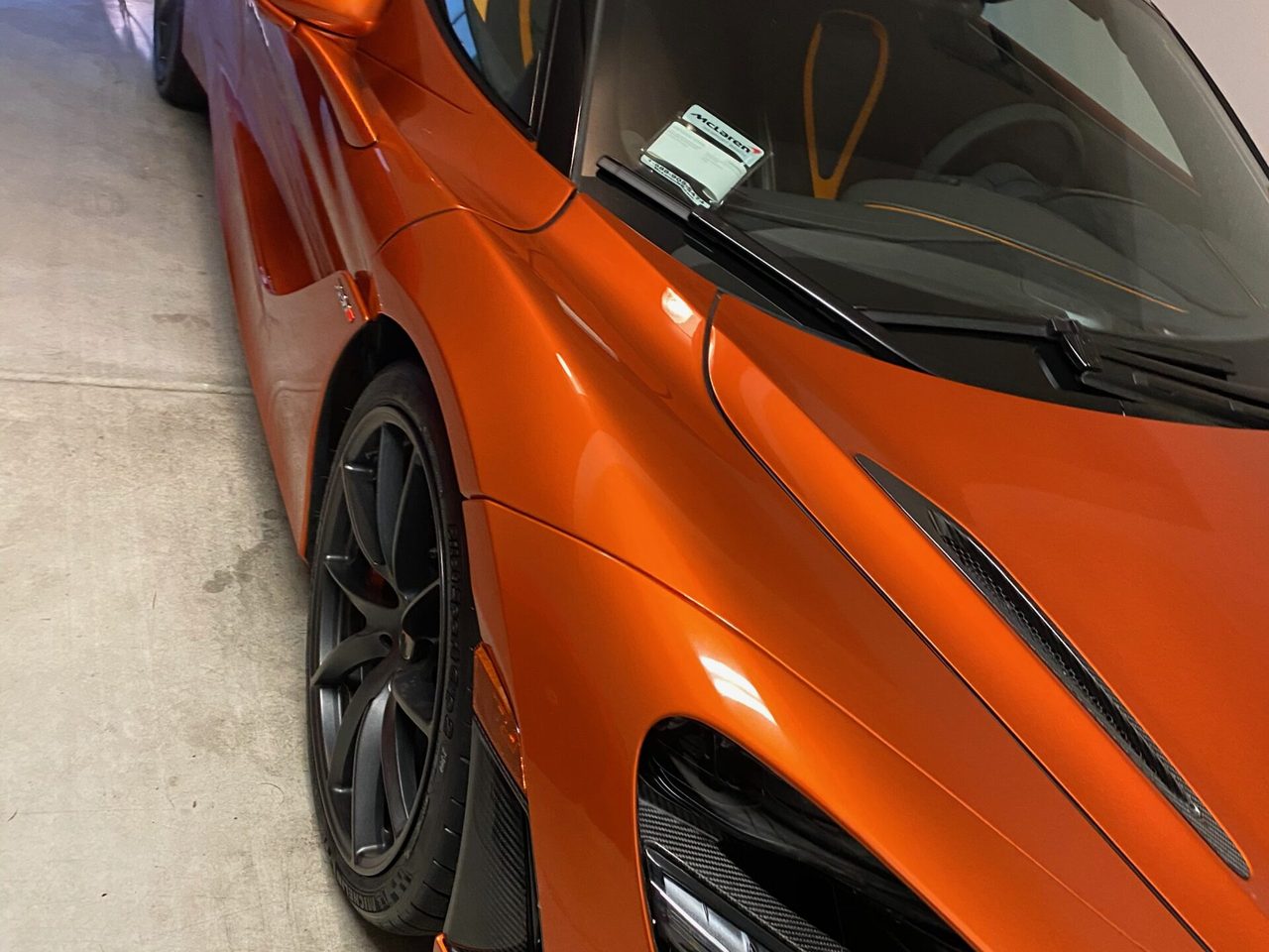 A McLaren supercar with a deep, mirror-gloss finish after detailing